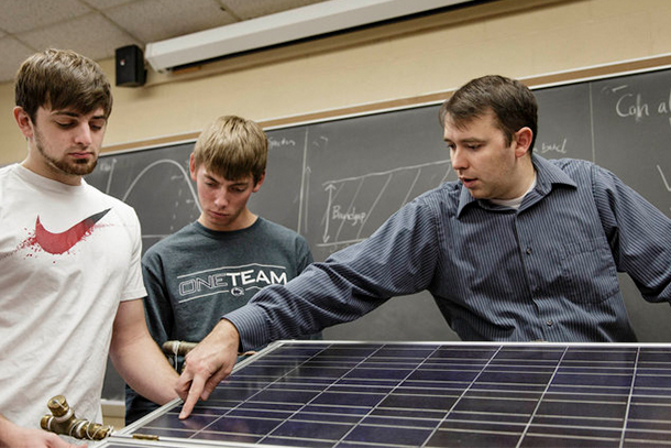 Assistant Professor of Engineering Joseph Ranalli talking to students about solar panels
