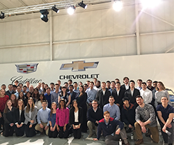 Students pose for a photo at a General Motors facility