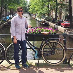 Patrick Duda stands on a bridge in Amsterdam. 