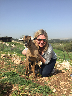 Anne Hoag makes a friend in Neot Kedumim Park where the students went through leadership training, which included herding goats