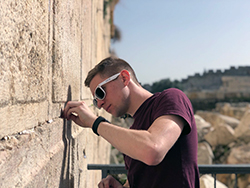 Ben Cutler putting a note in the Western Wall in Jerusalem.